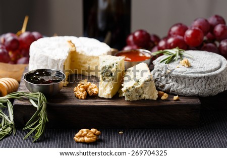 Cheese plate  served with wine, gam and honey close-up