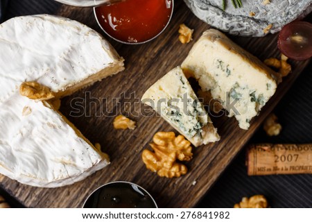 Cheese plate served with jam and honey top view