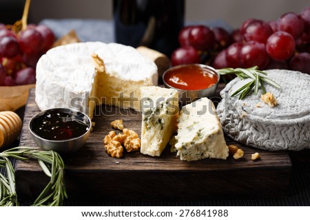 Cheese plate   served with wine, jam and honey close-up