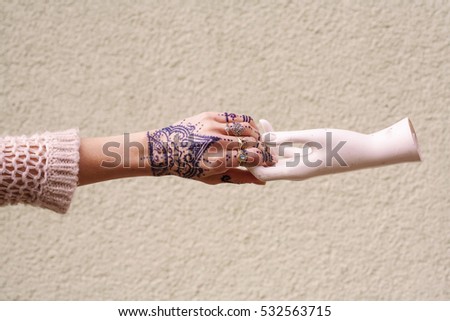 Fashionable hand with lots of rings and tattoo
