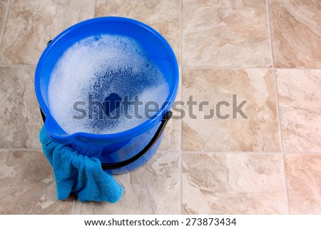Image of a bucket with rag and water for cleaning