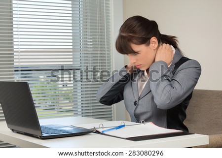 The image of business woman doing exercise at the office