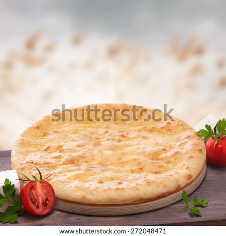 Ossetian pie, still life with flat cake, vegetables and cheese, food.