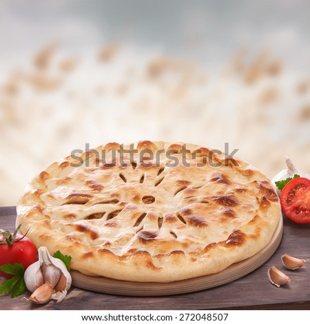Ossetian pie, still life with flat cake, vegetables, food.