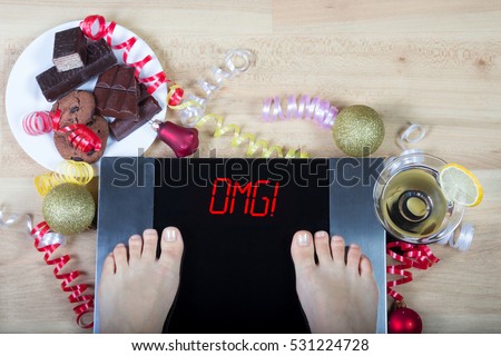 Digital scales with woman feet on them and sign