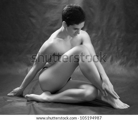 Black and white photo of a healthy naked woman with perfect body.