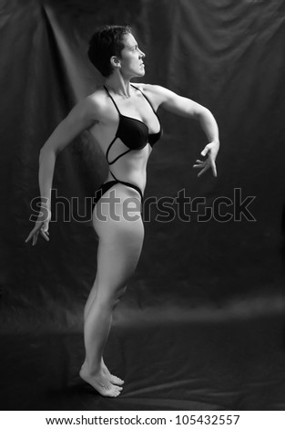 Black and white photo of a healthy fitness woman with perfect body.