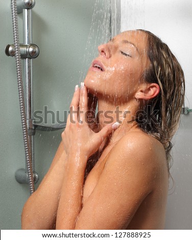 Young woman washing her perfect body in the bathroom.
