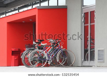 Several old bicycles at door to modern building. Ecology transportation concept.