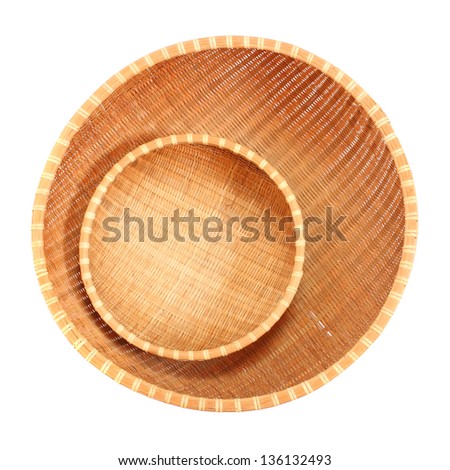 An empty wicker dish on white background.  Traditional rustic handmade product.