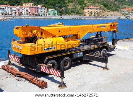 RIO MARINA, ITALY - JUNE 28: Big mobile crane Gottwald Tmk with load capacity 65000 kg. Vehicle for ship loading. June 28, 2013 in harbor of Rio Marina, Island of Elba, Italy.