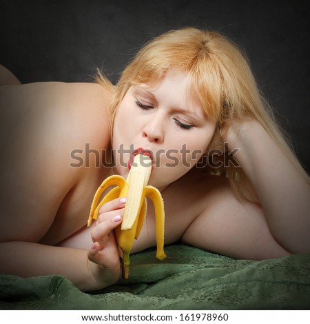 Blonde Woman Eating Fresh Ripe Banana On Black Background.