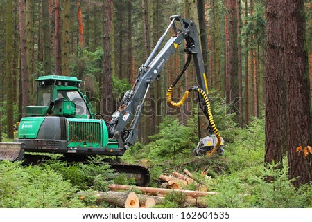 PILSEN CZECH REPUBLIC - NOVEMBER 11: unidentified lumberjack with modern harvestor working in a forest on November 11, 2013. Forestry is Czech\'s traditional industry with a very long history.