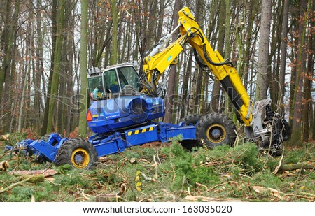 PILSEN CZECH REPUBLIC - NOVEMBER 14: unidentified lumberjack with modern harvestor working in a forest on November 14, 2013. Forestry is Czech\'s traditional industry with a very long history.