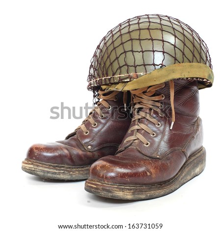 Retro military helmet and boots ( paratrooper's accessories) on a white background.