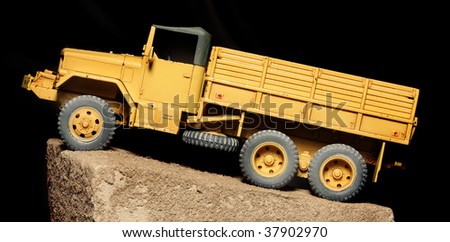 A Vintage Yellow Truck on Black Background - plastic kit 1:48 scale - close up