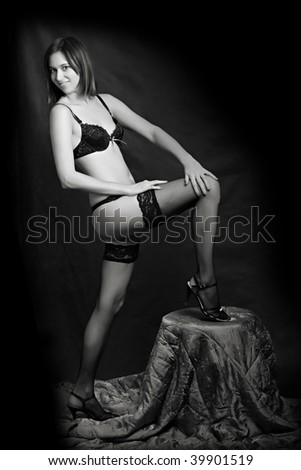 Low key lighting studio shot young attractive women in black sexy lingerie - monochrome studio shot