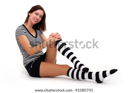 Sexy girl in funny socks . Studio shot over light grey background