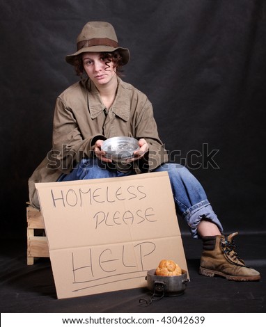 Young homeless in depression. Low key studio shot. Great for charity brochures and advertisements.