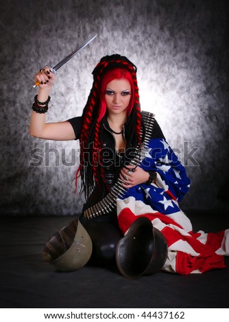 Portrait of bizarre red hair Gothic Girl with dagger. Low key studio shot. Great for calendar.