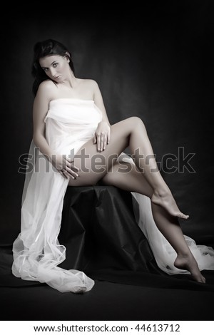 Beautiful slenderness young woman in bridal veil on black background. Low key studio shot. Great for calendar and Valentine advertising.