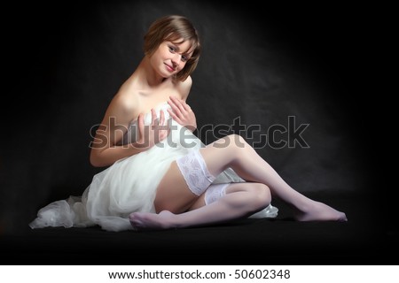 stock photo Beautiful slenderness young woman in bridal veil on black 