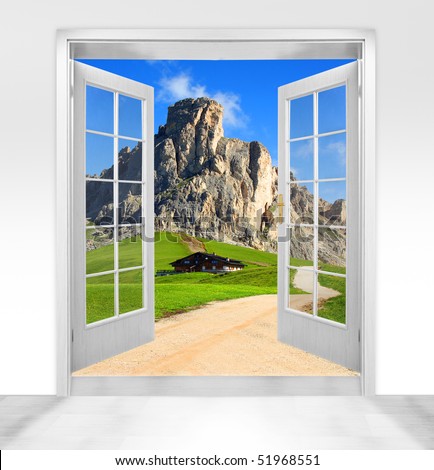 Opened wooden two-leaf door to beautiful mountain scenery. Conceptual image.