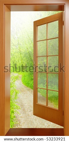 Opened door from tropical wood to early morning in green garden - conceptual image - environmental business metaphor.