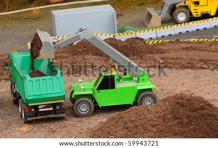 Green dumper and earthmover on a road building. Homemade RC model - plastic kit (  scratchbuild 1 : 32 scale)