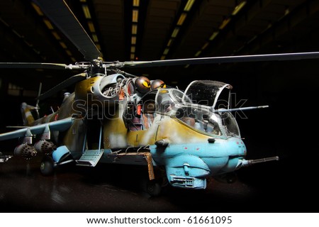 Battle helicopter in hangar (scale-model 1:24 scale). Marking is fictive. Close up with shallow DOF.