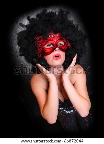Pretty showgirl with red mask and afro hair-style dancing on the carnival