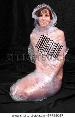 Foil-wrapped woman with bar code. Conceptual image