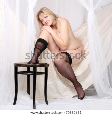 Picture of a worry overweight woman in a vintage bedroom.