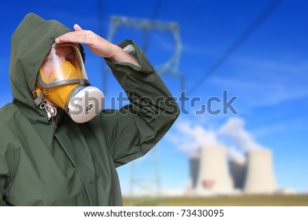 Worker in gas mask and chemical splash suit against a radioactive air pollution. Environmental hazard metaphor.
