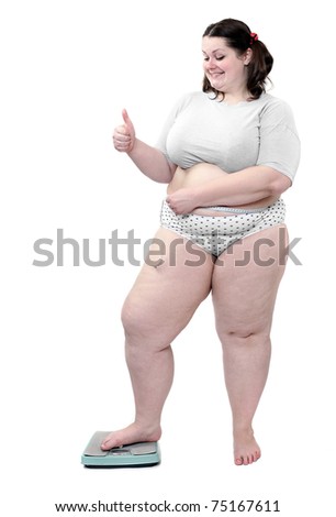 Happy overweight woman measure her waist belly by metre-stick on a weighing machine.