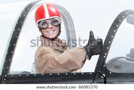 Retro style picture of a pilot in cockpit of a vintage plane. Close up with shallow DOF.