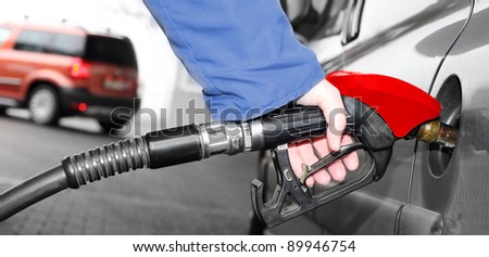 The driver pumping gasoline at the gas station.