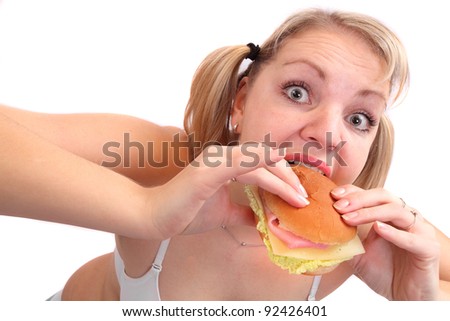 Funny picture of overweight woman eating tasty sandwich.