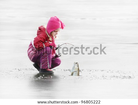 Little fisherman catching a fish on ice.