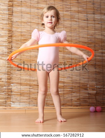 Little girl holding hula hoop.