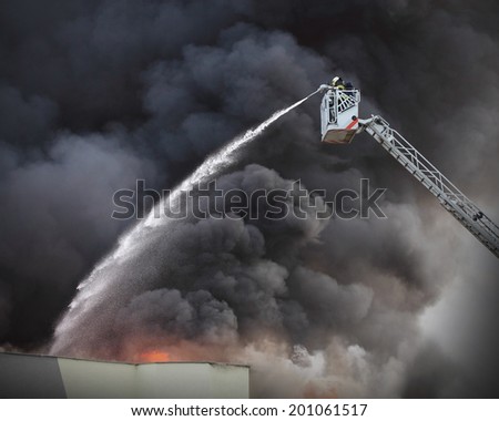 Firefighter and burning house.