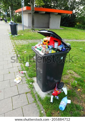 OFFENBERG, GERMANY - JULY 14 2014: Garbage and dirt on a pull off highway.  Routine situation every summer holidays. Waste management in European Union.