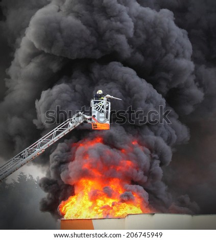 Firefighter and burning factory.