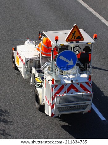 PILSEN CZECH REPUBLIC - AUGUST 19, 2014: Unidentified workers driving maintenance vehicle. Painting new road signs on highway D5 Praha - Rozvadov.