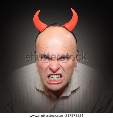 Funny picture of an angry man with devil horns. Mental health concept.