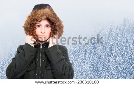 Young woman dressed in warm jacket with fur hood for frosty weather.