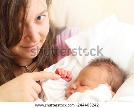 Young mother and her newborn baby girl together.