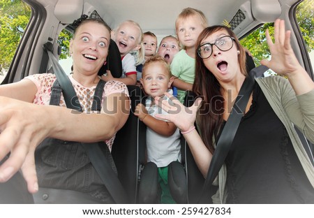 Crazy family taking a selfie in the car. Vintage filtered look
