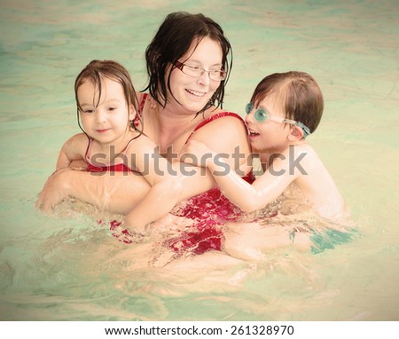 Retro style picture of happy family swimming together. Warm filtered look with soft focus.