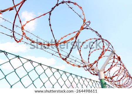 Fence with a barbed wire.